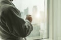 Businessman with cup of coffee inside his hotel room