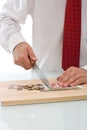 Businessman cutting the currency Royalty Free Stock Photo