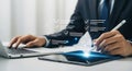 Businessman using stylus on tablet with digital checklist and laptop image Royalty Free Stock Photo