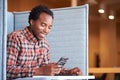 Businessman At Desk In Cubicle In Modern Office Work Space Using Mobile Phone Royalty Free Stock Photo