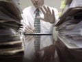 Businessman at Desk with Files Holding up Hand Royalty Free Stock Photo