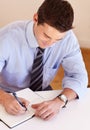 Businessman at desk with pen, notebook and smile, thinking and market research plan at startup. Office, notes and man Royalty Free Stock Photo