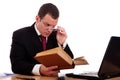 Businessman on desk reading and studying Royalty Free Stock Photo