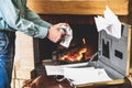 Businessman destroying important documents from case in fireplace Royalty Free Stock Photo