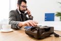 businessman dialing number with stationary telephone