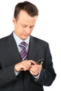 Businessman dials number on cellular telephone