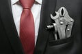 Businessman with different tools in suit pocket. Business creation concept. Auto repair business concept.