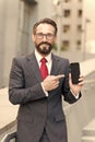 Business and digital gadget. smiling manager pointing finger at screen mobile phone Royalty Free Stock Photo