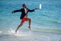 Businessman director running at the beach. director is very carefree businessman. summer inspiration for business man Royalty Free Stock Photo