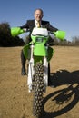 Businessman on Dirt Bike Royalty Free Stock Photo