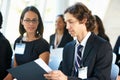 Businessman Discussing Conference Document With Colleague