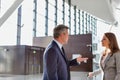 Businessman discussing plans with business partner in airport