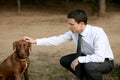 Businessman with dog outdoor in park