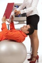 Businessman doing exercise with ball