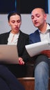 Businessman doing overtime helping coworker using laptop Royalty Free Stock Photo