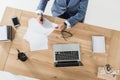 Businessman doing paperwork at workplace with laptop in office Royalty Free Stock Photo