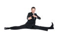 Businessman doing splits while gesturing over white background