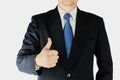 Businessman is doing thumps up sign over white background.