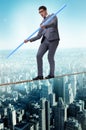 The businessman doing tightrope walking in risk concept Royalty Free Stock Photo