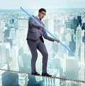 Businessman doing tightrope walking in risk concept Royalty Free Stock Photo