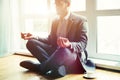 Businessman doing yoga in lotus pose Royalty Free Stock Photo