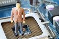 Businessman doll Stand on a computer motherboard.