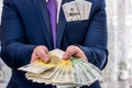 Businessman with dollar in pocket offering euro banknotes Royalty Free Stock Photo
