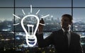 Businessman drawing bulb Royalty Free Stock Photo