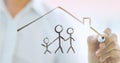 Businessman drawing family icon and house for home and health insurance Royalty Free Stock Photo