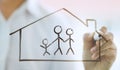 Businessman drawing family icon and house for home and health insurance Royalty Free Stock Photo