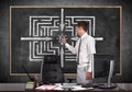 Businessman drawing labyrinth Royalty Free Stock Photo