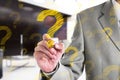 Businessman drawing a yellow question mark. Business concept Royalty Free Stock Photo