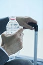 Businessman drinking bottled water at the airport Royalty Free Stock Photo