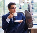 Businessman drinking coffee in the office during break Royalty Free Stock Photo