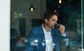 Businessman drinking a cup of coffee inside of a cafe