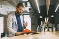 Businessman drinking water and reading paper Royalty Free Stock Photo