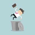 Businessman dropped into trashcan layoff concept.
