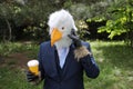 Businessman with an eagle face making a phone call Royalty Free Stock Photo