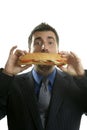 Businessman eating junk fast food