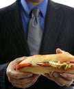 Businessman eating junk fast food