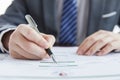 Businessman in elegant suit at a business meeting signing contracts in the office Royalty Free Stock Photo