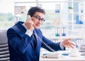 Businessman employee talking on the office phone Royalty Free Stock Photo