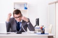 The businessman employee talking on the office phone Royalty Free Stock Photo