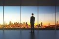 Businessman in empty office looking at beautiful skyline Royalty Free Stock Photo