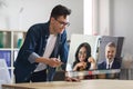 businessman engaging in online conference call with diverse colleagues indoor Royalty Free Stock Photo