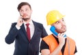 Businessman and engineer having a conversation on cellphone Royalty Free Stock Photo