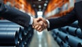 Businessman and Engineer Shaking Hands in Successful Collaboration at a Storehouse
