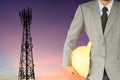 Businessman engineer and telecommunication tower at sunset