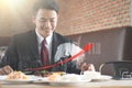 Businessman holding fork and knife eating steak, business and food/restaurant concept Royalty Free Stock Photo