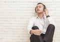Businessman enjoy listening music using headphones